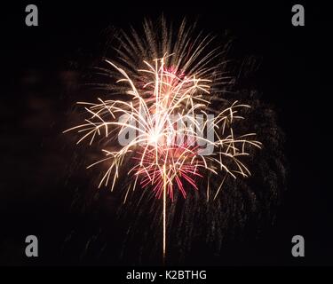 Fireworks burst in the air on 4th of July. Stock Photo