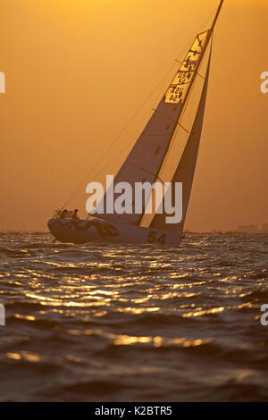 Yacht sailing at sunset at the Atlantic Cup race start, Charleston, South Carolina to New York, USA, May 2012. Stock Photo
