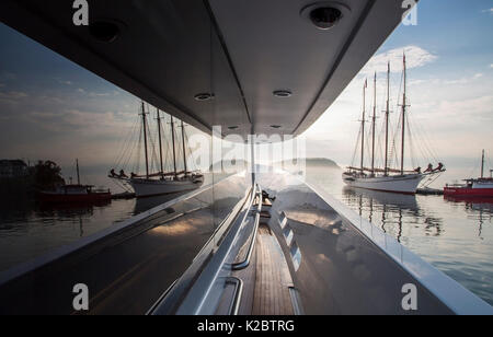 View of sailing boat reflected in window of yacht 'Trisara, 130' Westport' in Bar Harbor, Maine, USA, August 2013. Stock Photo