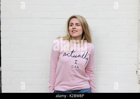 Young blonde woman in her early twenties wearing motivational jumper