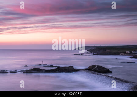View overlooking Bude breakwater/ harbour at sunset, Bude, Cornwall, UK. April 2015. Stock Photo