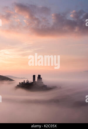 Corfe Castle at dawn with mist, Corfe Castle, Dorset, UK. September 2014.