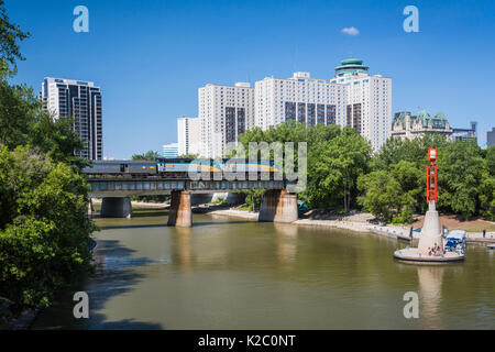 The Assiniboine River, a CN train at the Forks National Historic site ...