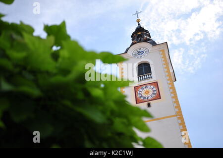 Catholic church bell rising from beyond the trees Stock Photo