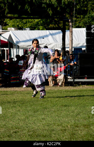 Native American powwow dancer in full traditional regalia at dusk ...