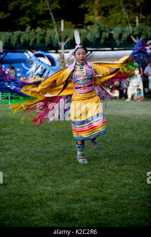A women's Fancy Shawl dancer competes at a pow wow. Stock Photo