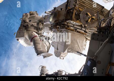 NASA International Space Station Expedition 51 prime crew member American astronaut Peggy Whitson works on the outside of the ISS during an EVA spacewalk May 12, 2017 in Earth orbit. Stock Photo