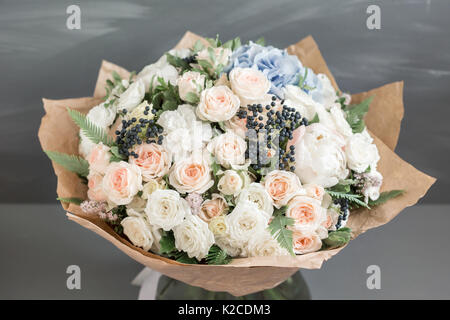 Rich bunch of peonies, roses and hydrangea flowers, green leaf. Fresh spring bouquet. Summer Background. Selective focus. Stock Photo
