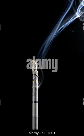 White lit cigarette on a black background, with lots of smoke coming from the side, bottom and top, and ash on the smoke Stock Photo
