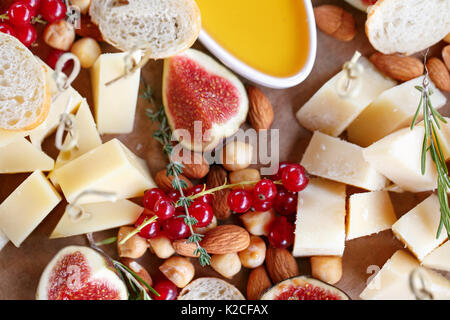 Assortment of cheese on wooden board. snacks on the buffet table Stock Photo