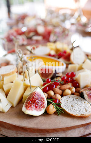 Assortment of cheese on wooden board. snacks on the buffet table Stock Photo