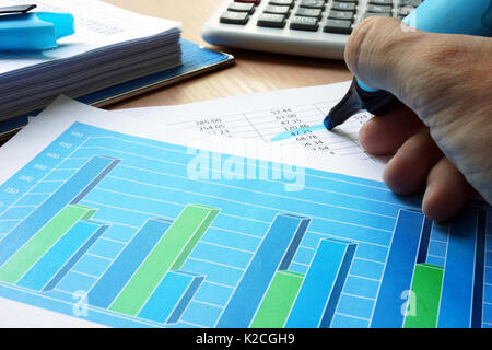 Auditor is underlined financial data in a business report. Stock Photo