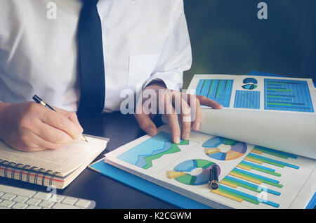 Business man or accountant working with financial papers and invoices. Stock Photo