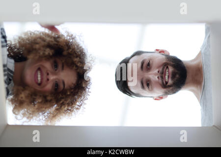 View from the bottom of the newlyweds looking inside the box. Stock Photo