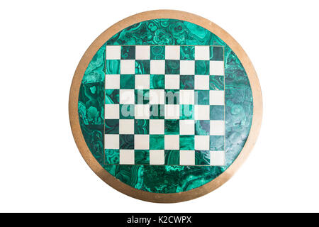 Shiny round green stone empty vintage old chess board from above with golden yellow frame on isolated white background. Stock Photo