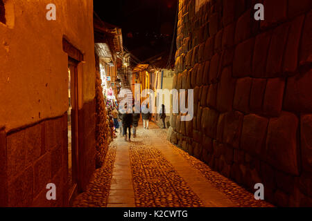 Historic Inca stonework on Calle Hatunrumiyoc at night, Cusco, Peru, South America