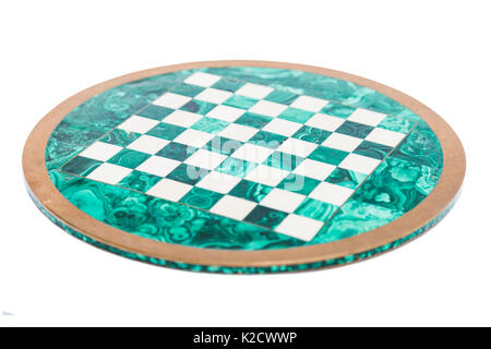 Shiny round green stone empty vintage old chess board from above with golden yellow frame on isolated white background. Stock Photo