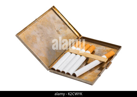Shiny metal old vintage used scratched shabby opened cigarette case with corrosion and five new cigarettes with orange filters on isolated white backg Stock Photo