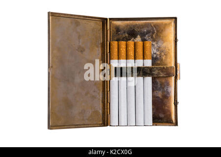 Shiny metal old vintage used scratched shabby opened cigarette case with corrosion and five new cigarettes with orange filters on isolated white backg Stock Photo