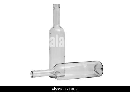 Glass transparent clean empty two shiny beautiful simple classic bottles lying and standing on isolated white background. Stock Photo