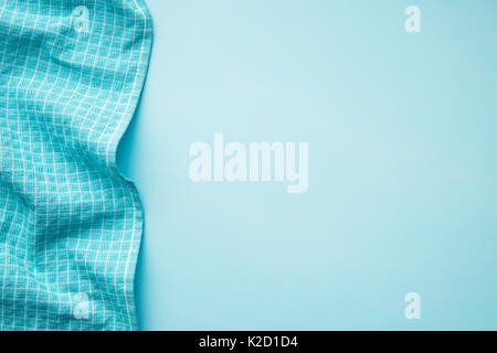 Tablecloth over blue background. Top view of tablecloth border. Stock Photo