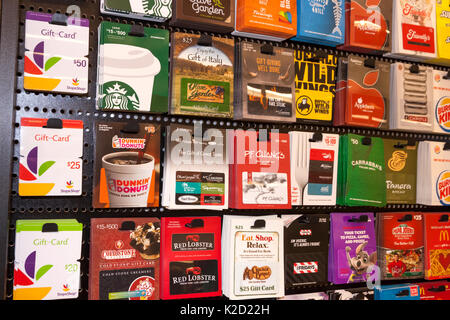 Restaurant, food, and drink gift cards for sale on a store display rack ...