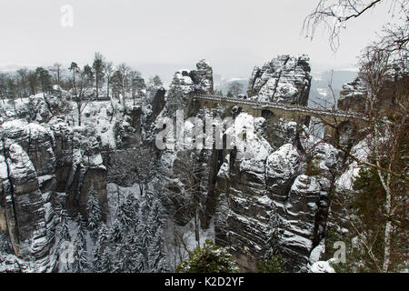 Bastei bridge through sandstone rock formations covered in snow, Sachsische Schweiz / Saxon Switzerland National Park, Germany, June 2010 Stock Photo