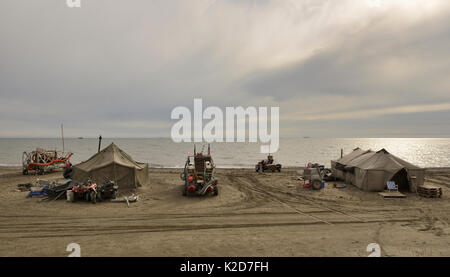 Gold dredgers and tents on beach, Sewards Peninsula, Nome, Alaska, USA, September. Stock Photo