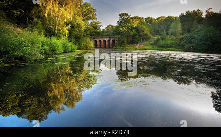 Viaduct Bridge and reflected in still water, Hampstead Heath, London, England, UK. September. 2012. Stock Photo