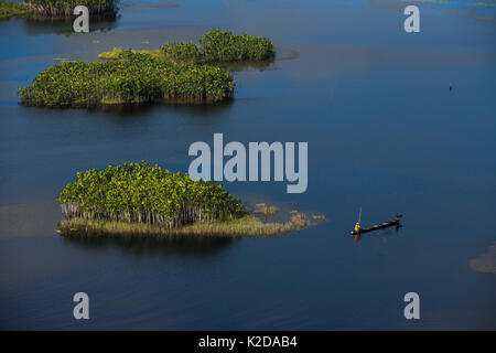 Fisherman in boat in West Demerara Conservancy, west of Georgetown, Guyana, South America Stock Photo