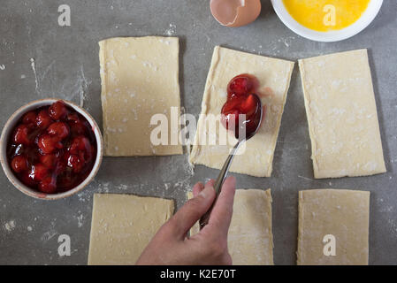 Making homemade cherry pies Stock Photo