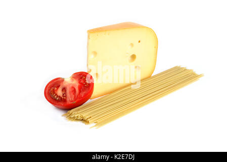 Big piece of cheese near spaghetti and tomato on white background Stock Photo