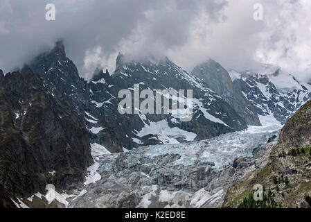 Aiguille Noire de Peuterey, part of the Peuterey ridge to the summit of Mont Blanc with its higher neighbour, the Aiguille Blanche de Peuterey seen from the Val Ferret valley, Graian Alps, Italy, June 2015 Stock Photo