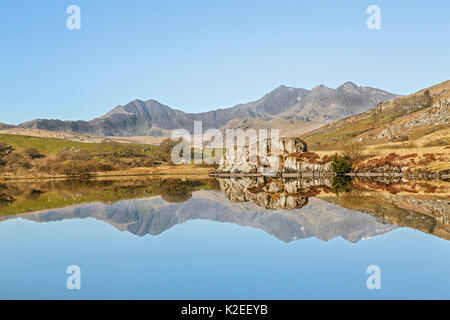Llynnau Mymbyr with Snowdon Mountain range viewed from the west, near Capel Curig, Snowdonia National Park, North Wales, UK, April. Stock Photo