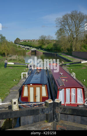 Narrow boats in a lock on the Kennet and Avon canal, Caen Hill, Devizes, Wiltshire, UK, April 2014. Stock Photo