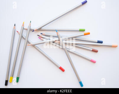Coloured Pencils Lying in disarray on a white background, learn to draw, step by step Stock Photo