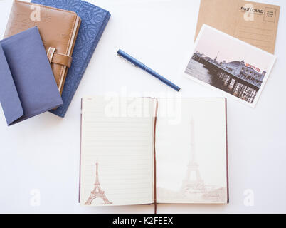 Concept from different type of notebooks, blue envelope and post cards on a white background. Stock Photo