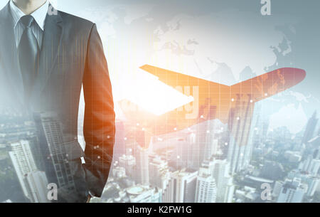 Businessman and airplane with graph, city and world map background Stock Photo