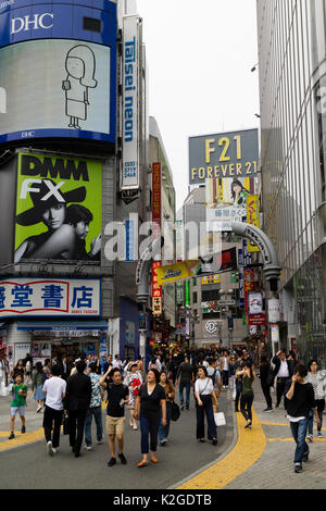 Tokyo, Japan - May 12, 2017: Pedestrians and advertisement signs in Shibuya shopping street Stock Photo