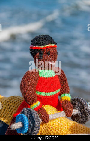 knitted weight lifter yarn bombing on saltburn pier for the olympic games Stock Photo