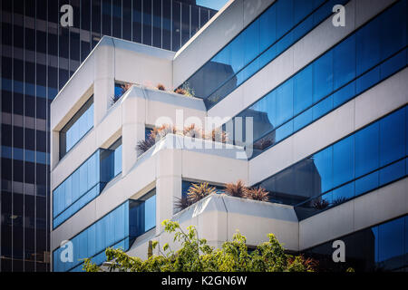 Fragment of modern multistory building in business district of Los Angeles California. Transparent contemporary architecture in hi-tech / minimalism s Stock Photo