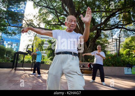 Group of men practising morning tai Chi gym in Kowloon park in Hong Kong Stock Photo