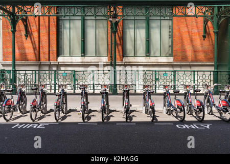 A row of Santander hire bikes on a street near Covent Garden in London. Stock Photo