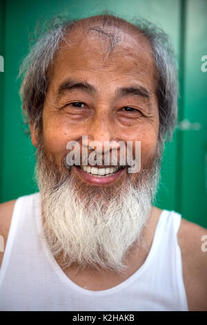 Portrait of older man smlie smiling  in Hong Kong China with beard Stock Photo