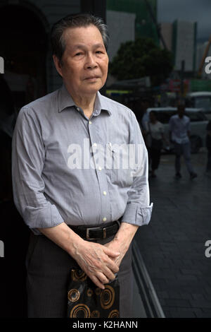 Old local chinese man posing in the streets of Hong Kong