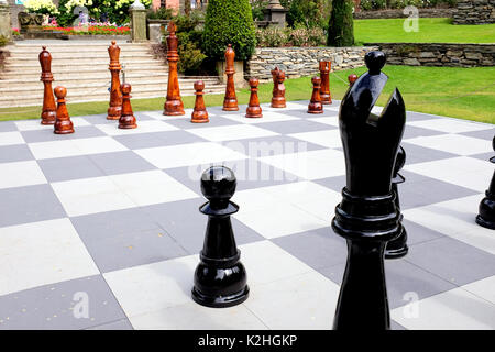 Portmeirion, Wales, UK. August 01, 2017. A giant wooden Chess set set out in the gardens in the village of Portmeirion in North Wales. Stock Photo