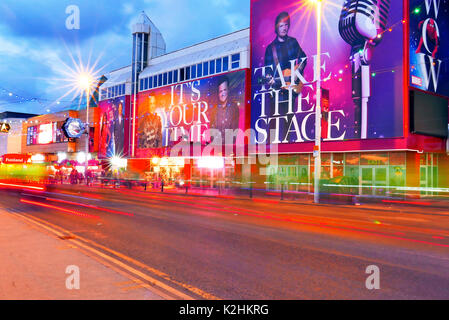 Light trails from bicycles riding along Blackpool Promenade in front of Madame Tussaud's waxworks during the annual Ride the Lights event at the start Stock Photo