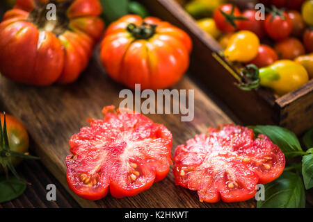 Red tomato cut in half on board. Stock Photo