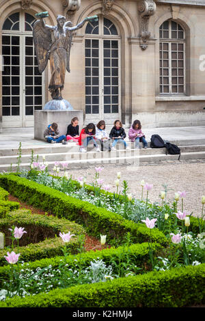 Young art students creating drawings at Hotel Carnavalet in the Marais, Paris France Stock Photo