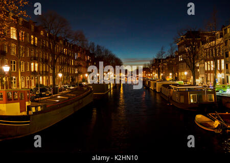 A night time view of a canal in Amsterdam, The Netherlands Stock Photo
